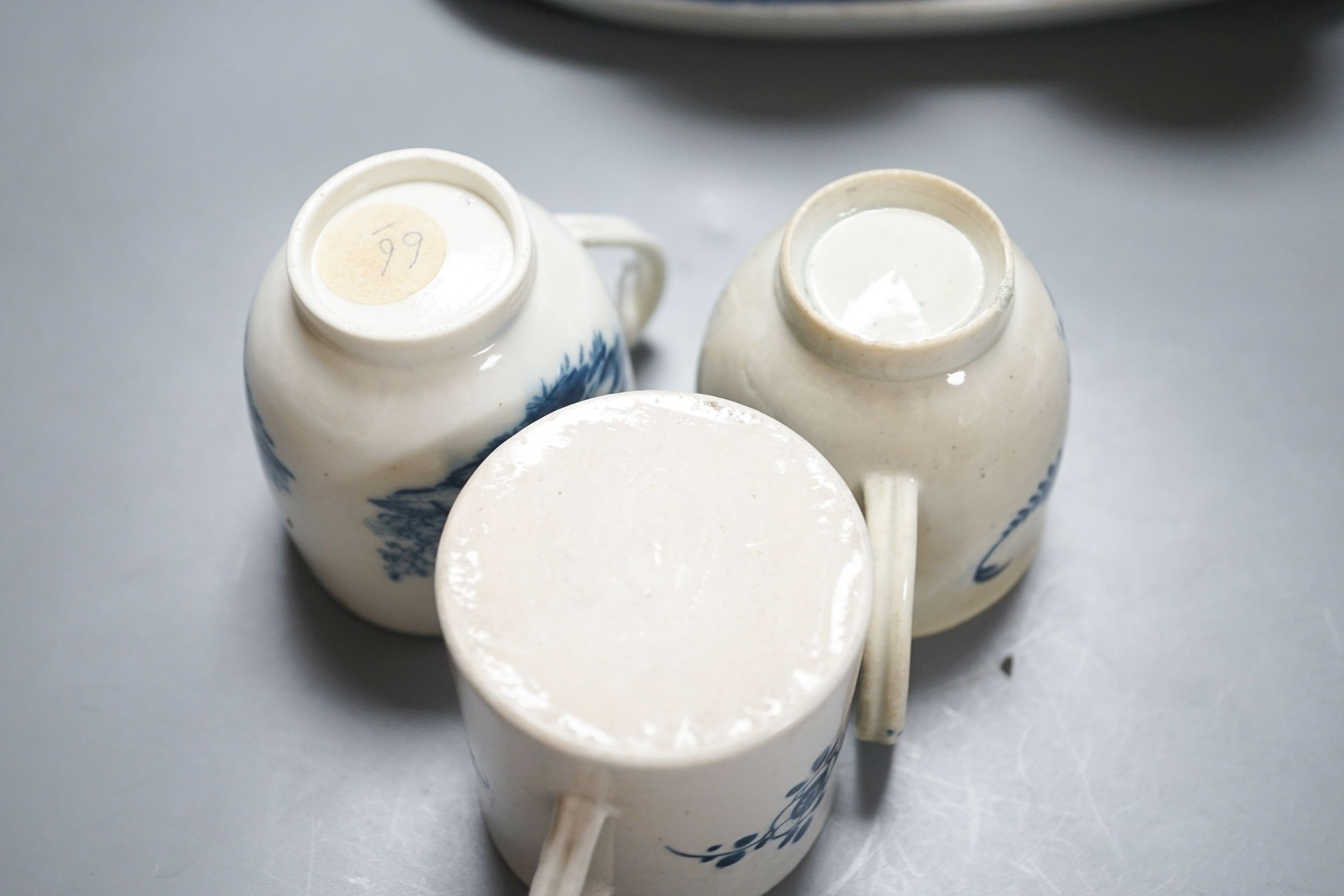 A group of Worcester and Caughley blue and white tea and coffee wares, late 18th century including fisherman pattern, three flowers pattern, chinoiserie figures etc.